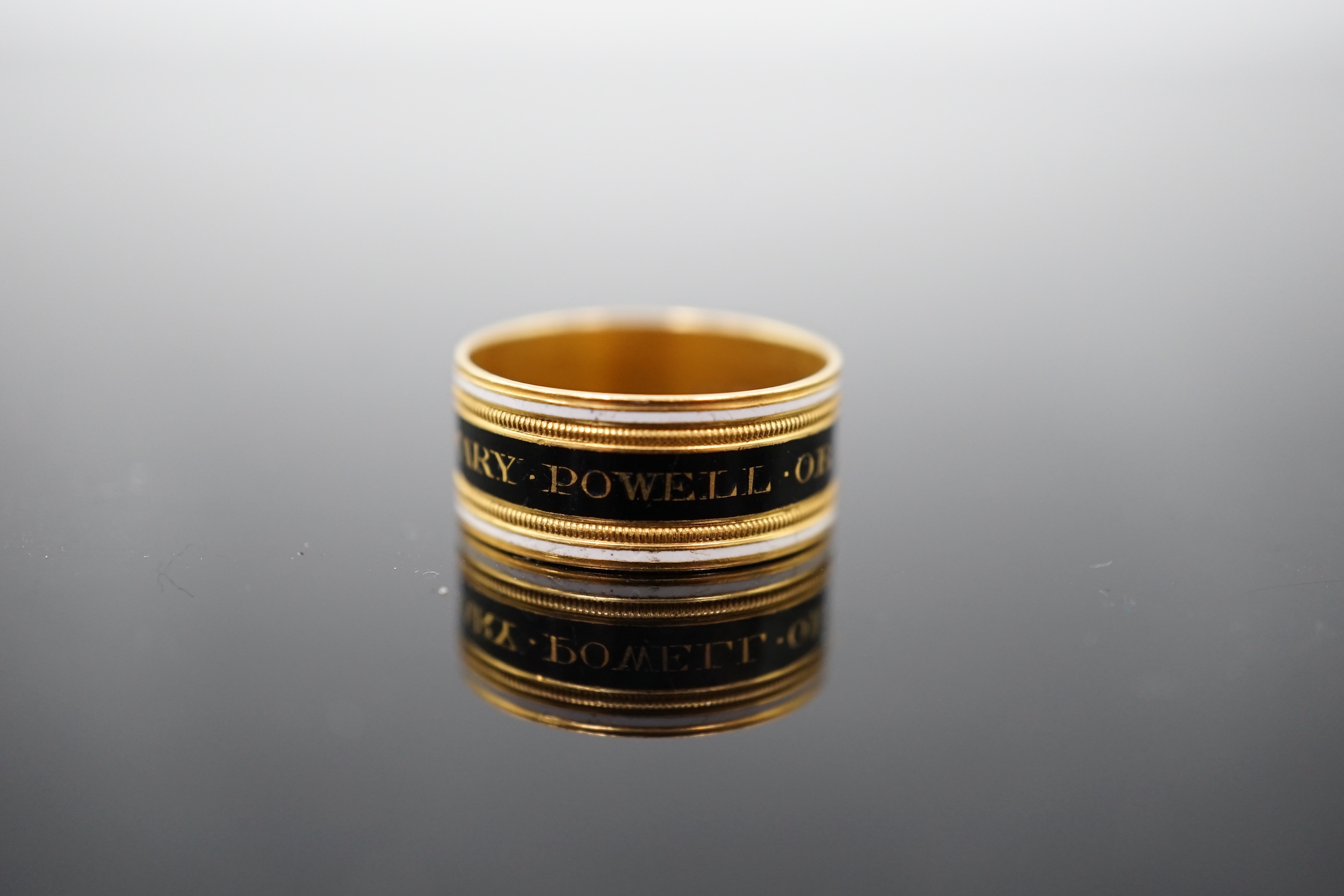 A George III 22ct gold and two colour enamel mourning band, inscribed 'Mary Powell OB. 12 Mar, 1809'